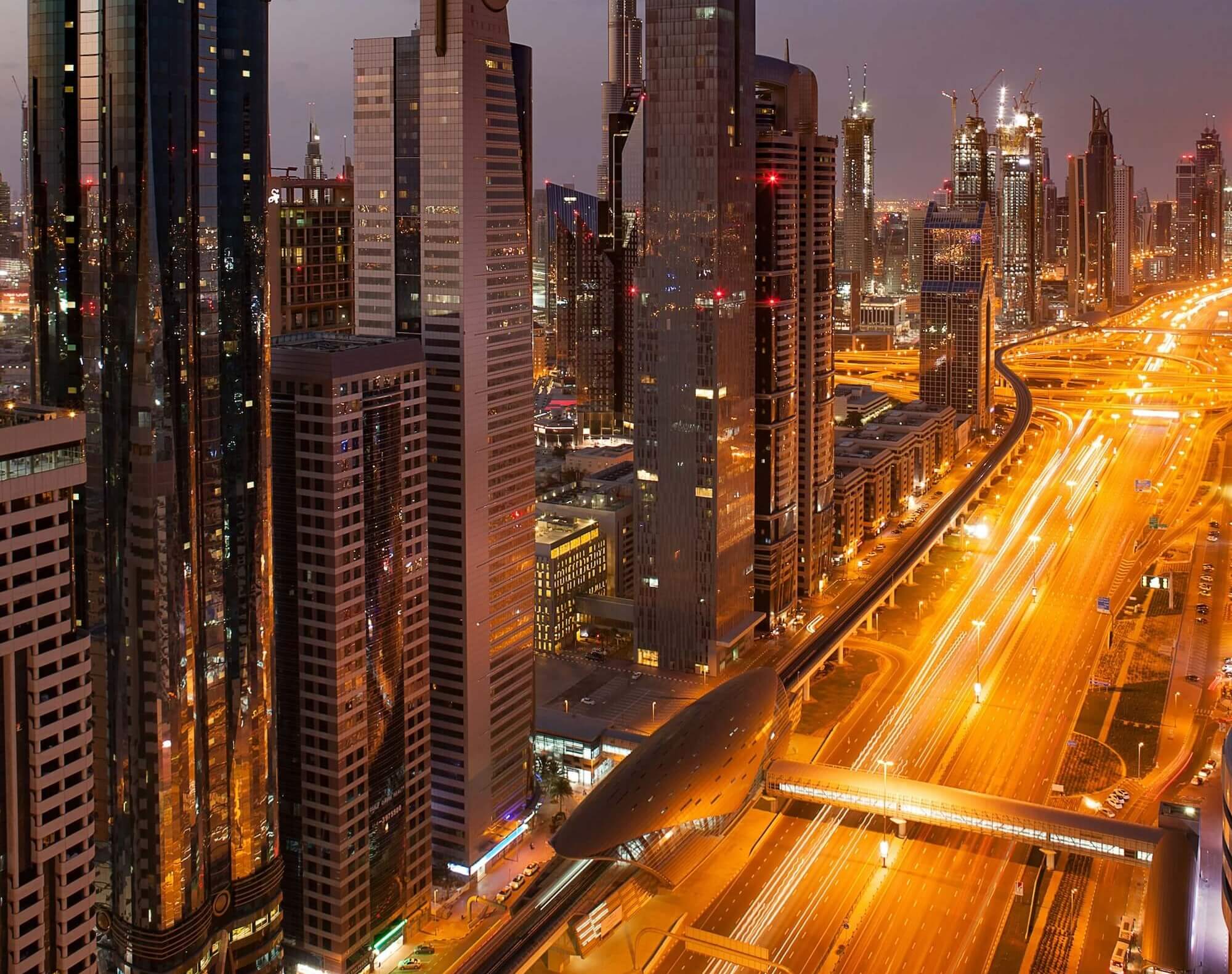 Dubai traffic and skyline at night